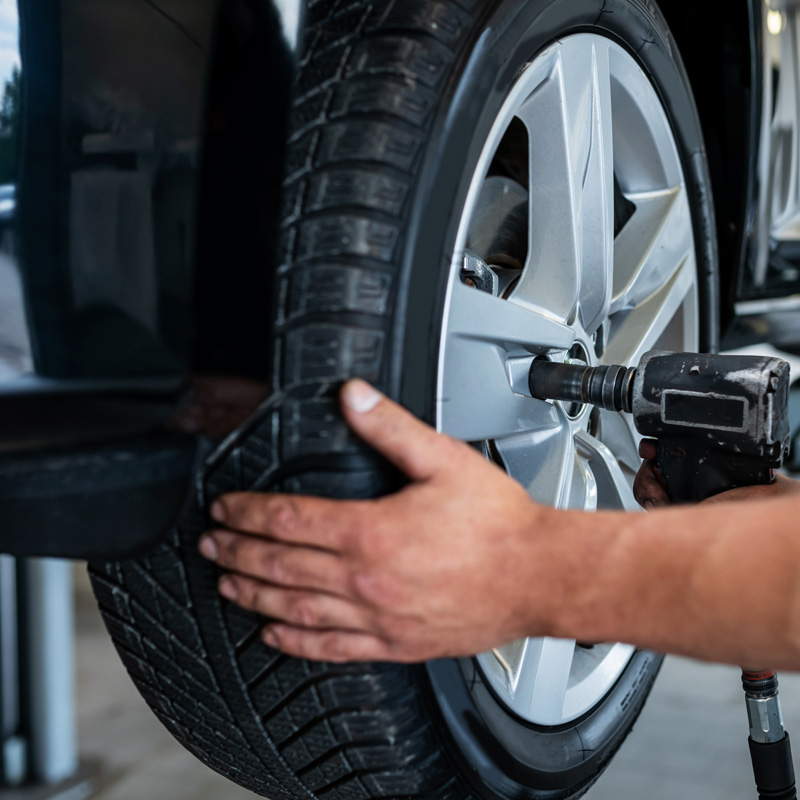 air wrench on lug nuts of a tire