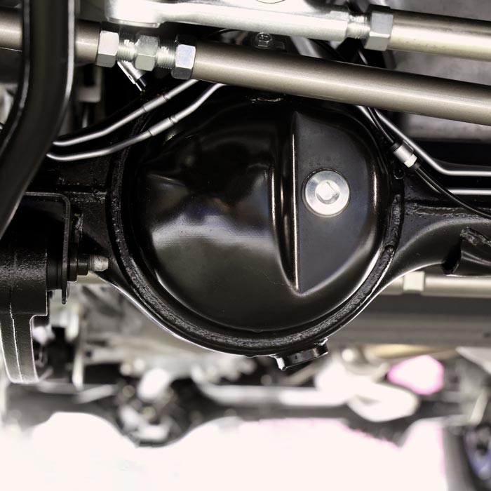 Car suspension part. Close up of a rear car suspension and exhaust system. such as coil springs link arms axle housing and performance exhaust.