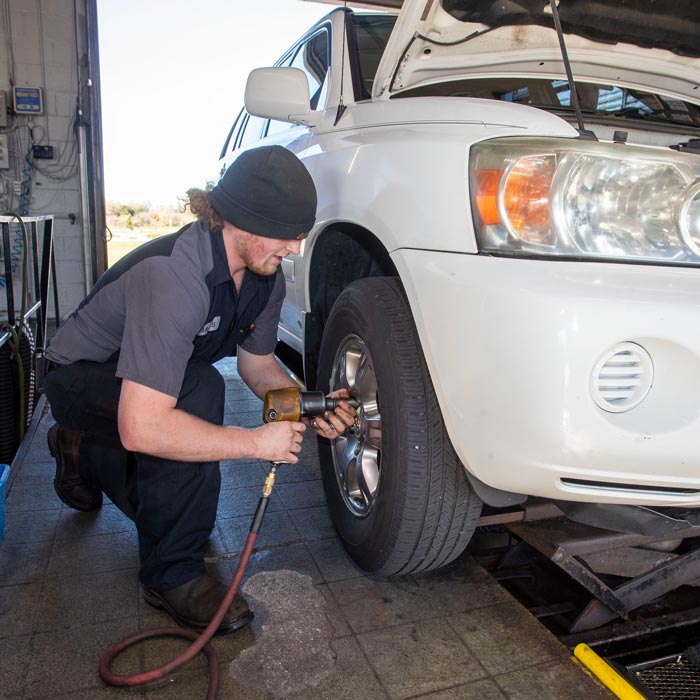 car mechanic changing tire